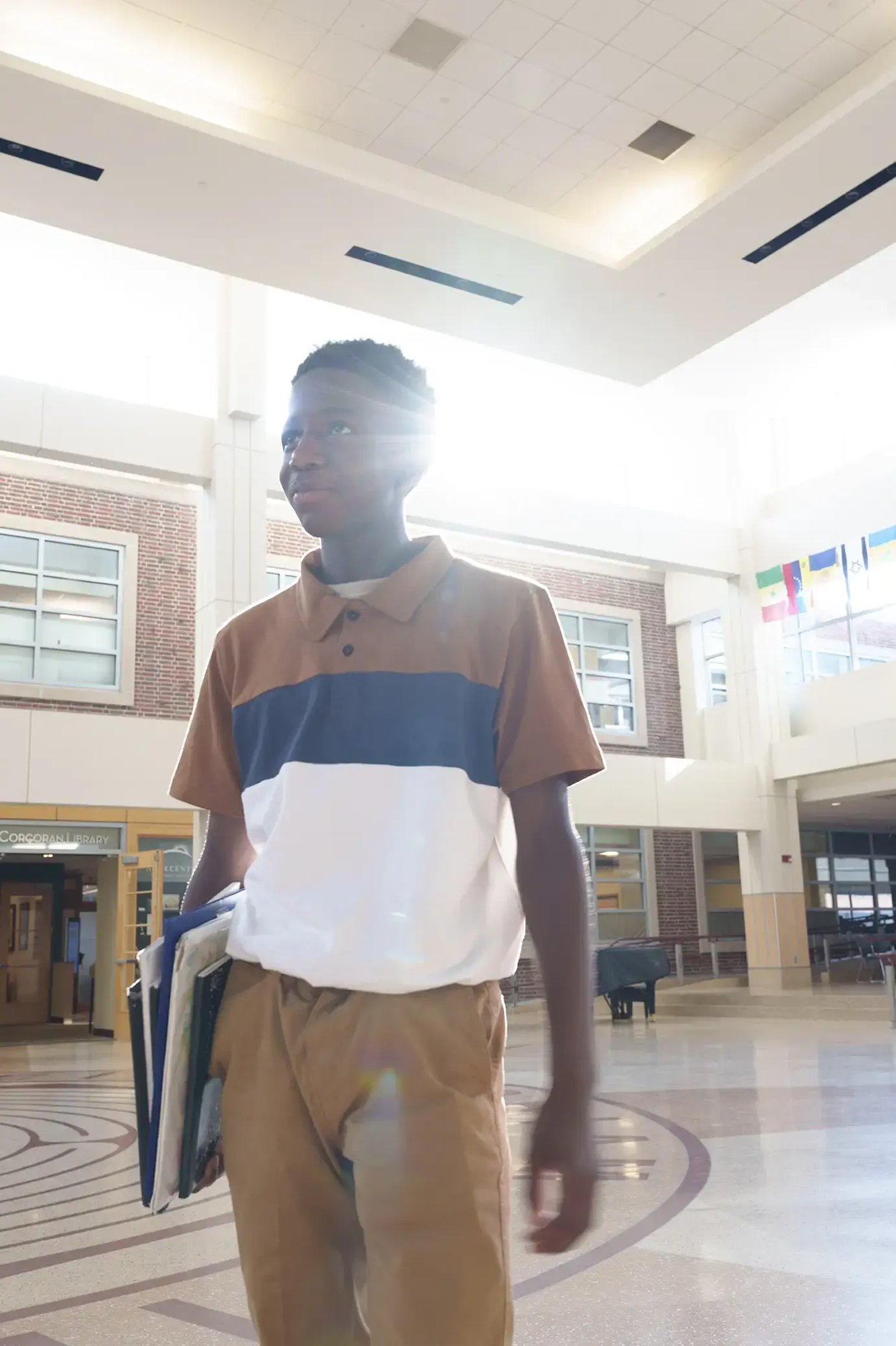 student in commons looking away light behind